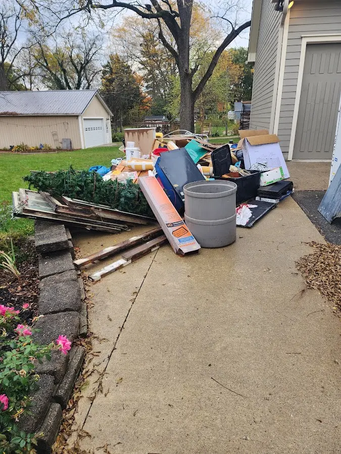 Dumpster being loaded with debris for Roofing Dumpster Rental in Grant